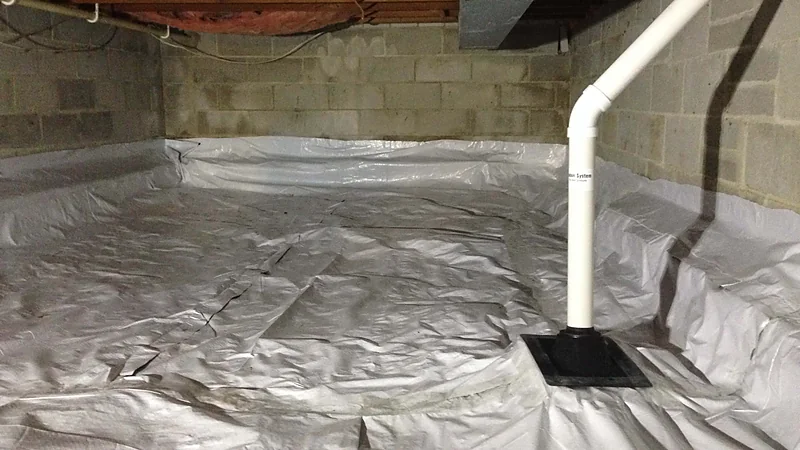 A sealed polyethylene membrane covering a crawl space floor with a vent riser booted through it